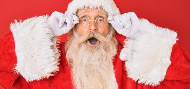 santa claus with red background by krakenimages courtesy of Unsplash.